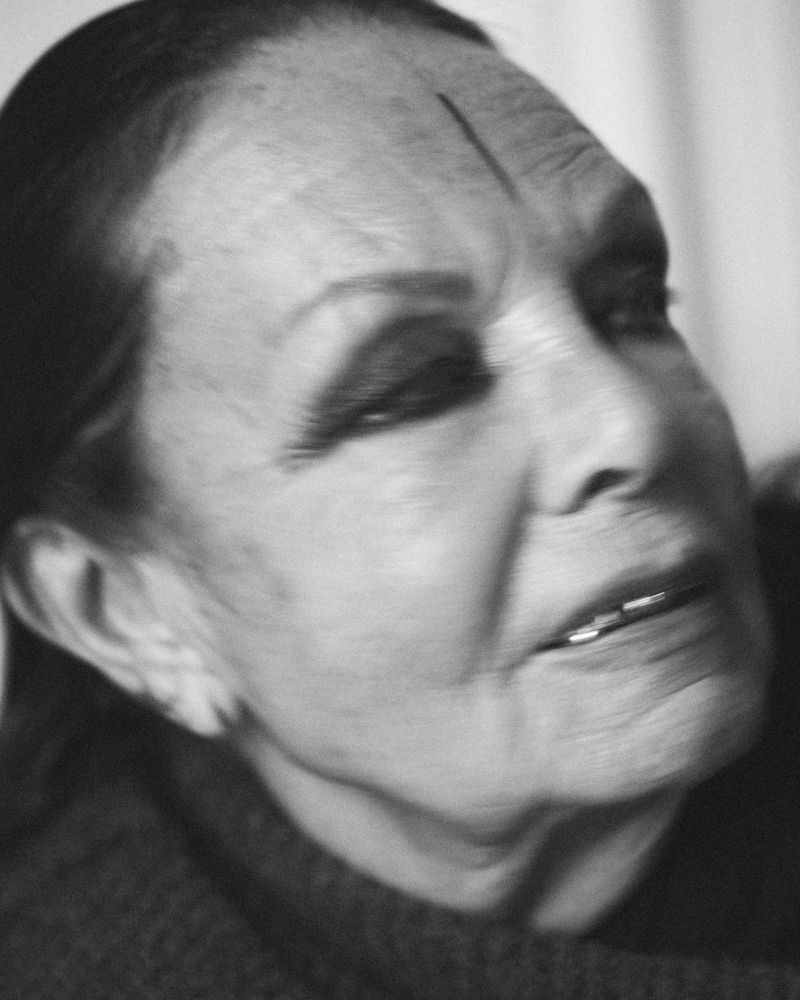 Striking black-and-white portrait of an elderly adult female with intense gaze, emphasizing age and character with detailed facial features.