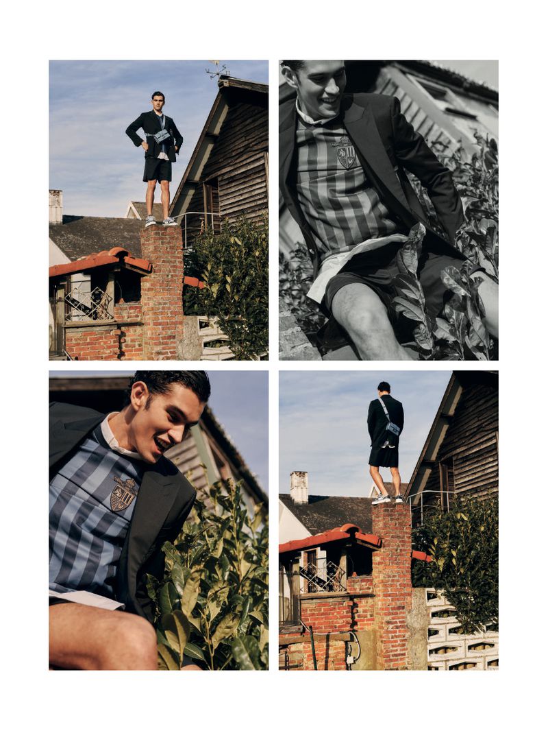 Fashion editorial quadrilayout: young man in blazer and shorts poses atop brick chimney against houses and sky, smiling, stylish.