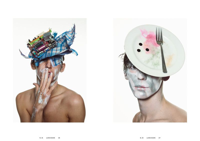 Avant-garde portrait of two young adults with creative makeup and headwear made of fabric, electronic parts, plates, and forks on white.