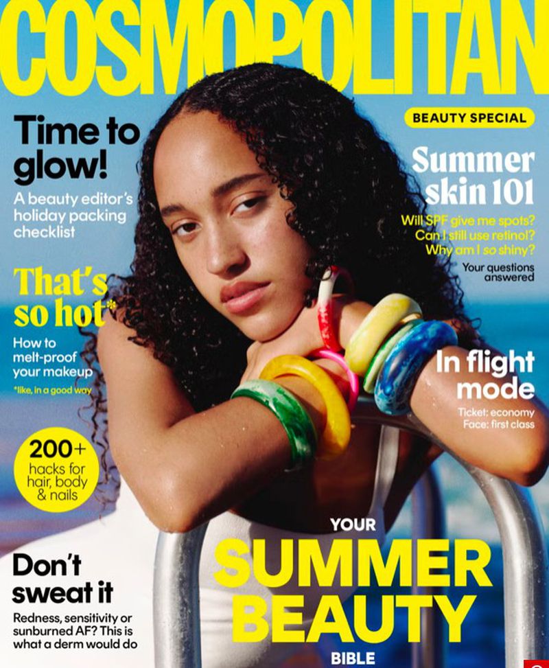 Cosmopolitan cover featuring a young adult female model with curly hair, wearing bangle bracelets, and posing outdoors with text overlays.