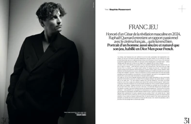 Monochrome magazine editorial portrait of French actor Raphael Quenard wearing a dark blazer against a plain white wall.
