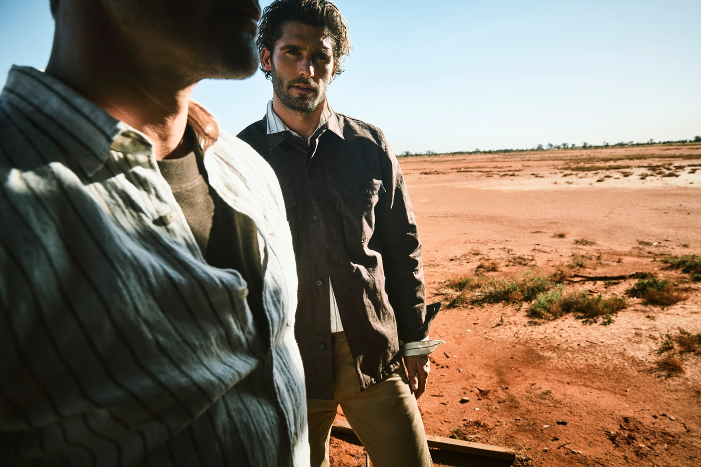 Two men standing in an arid desert landscape for a Country Road campaign, photographed by Simon Lekias.