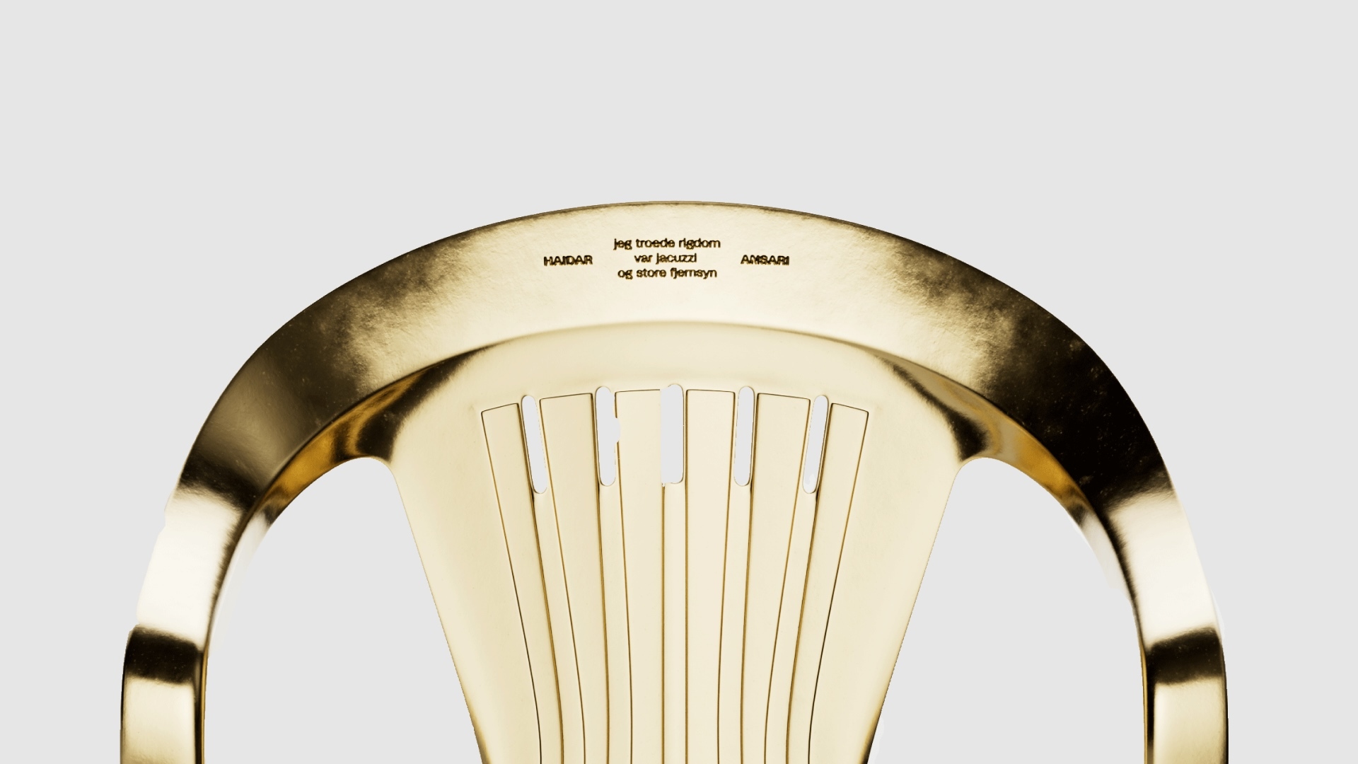 Close-up shot of a golden chair with text on its surface against a plain background, emphasizing texture and design.