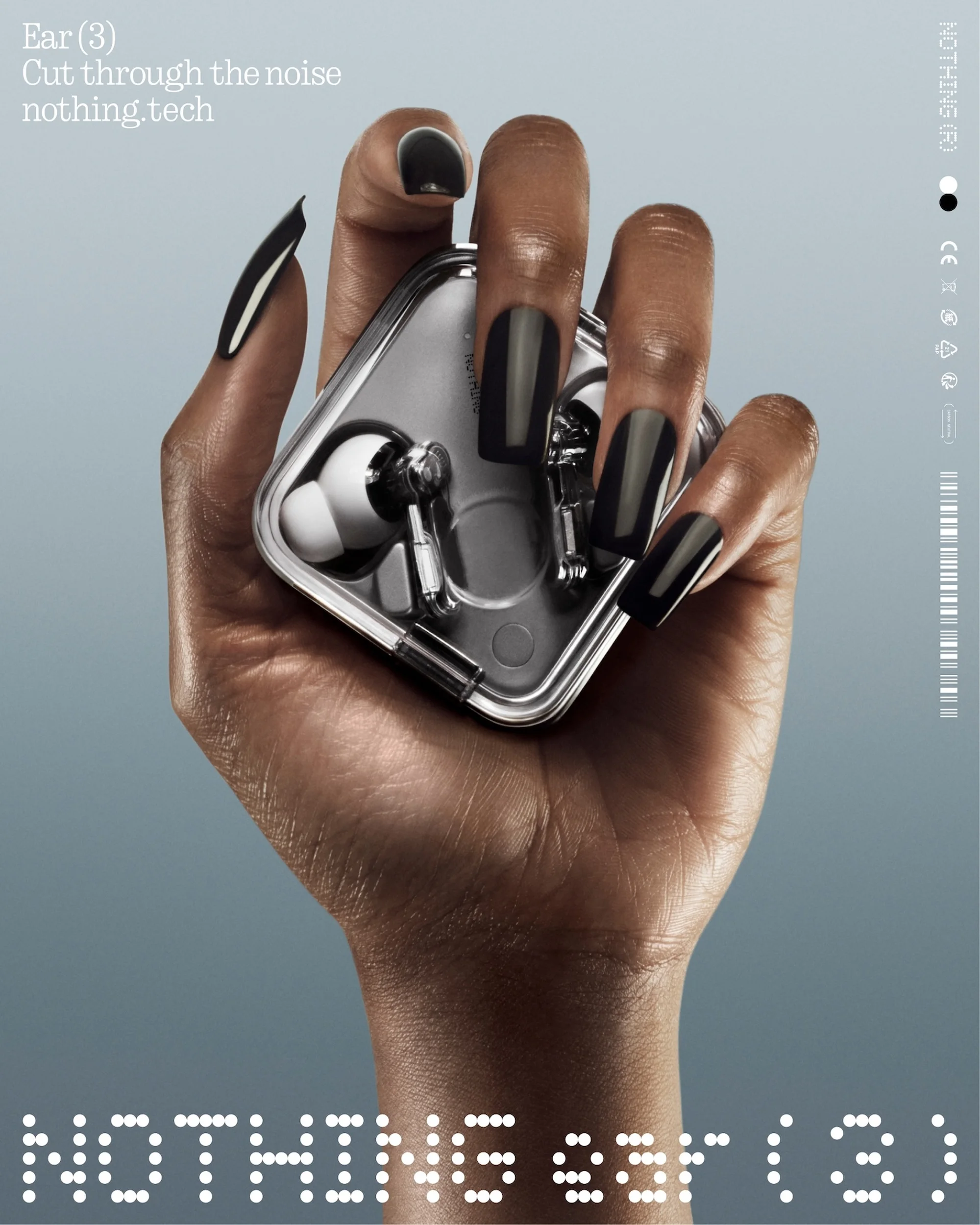 Hand holding silver 'Nothing Ear (3)' wireless earbuds; dark nail polish, light blue background, clean studio product shot, modern aesthetic.