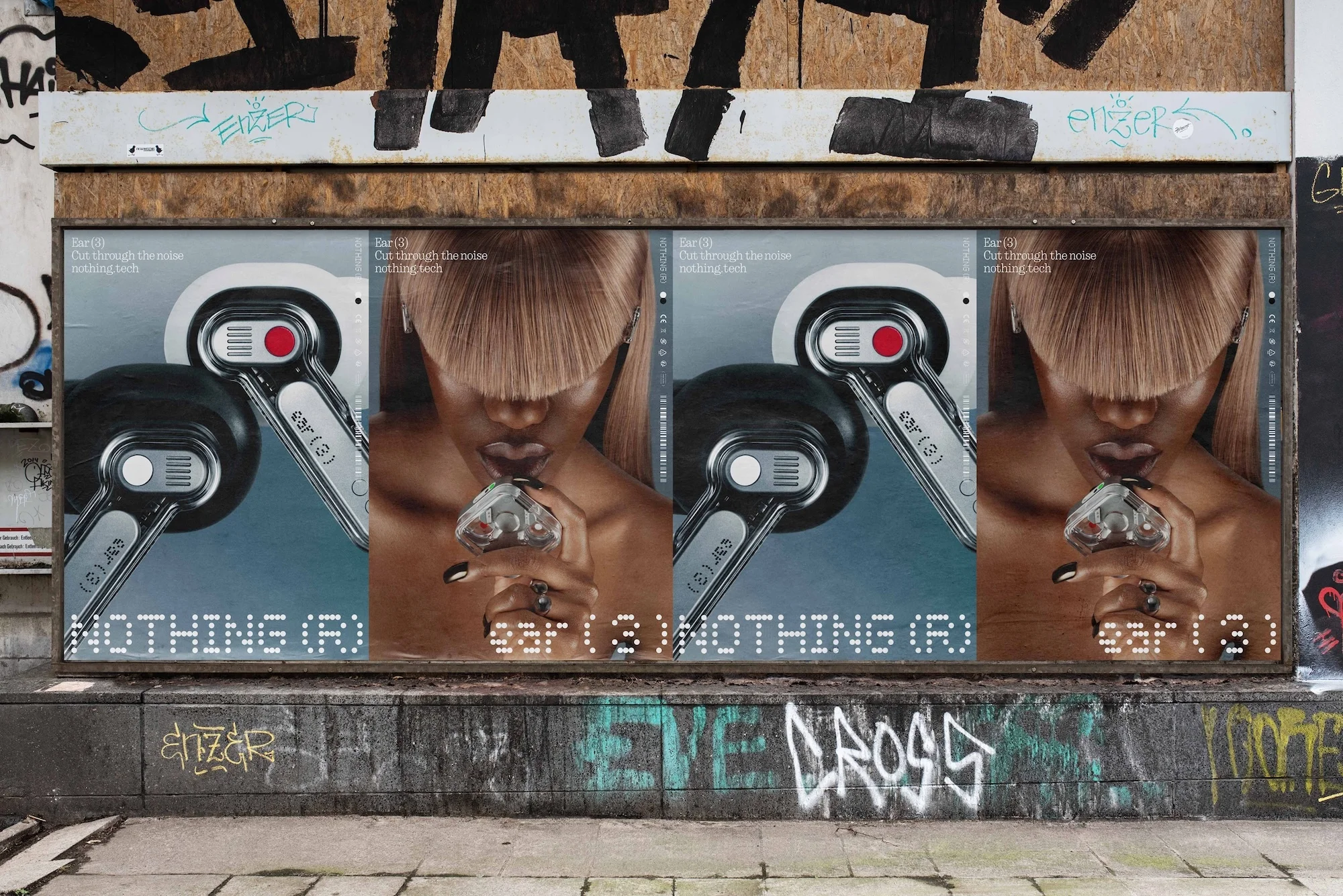 Outdoor billboard featuring an ad with a woman and audio devices on a graffiti-covered wall in an urban environment.
