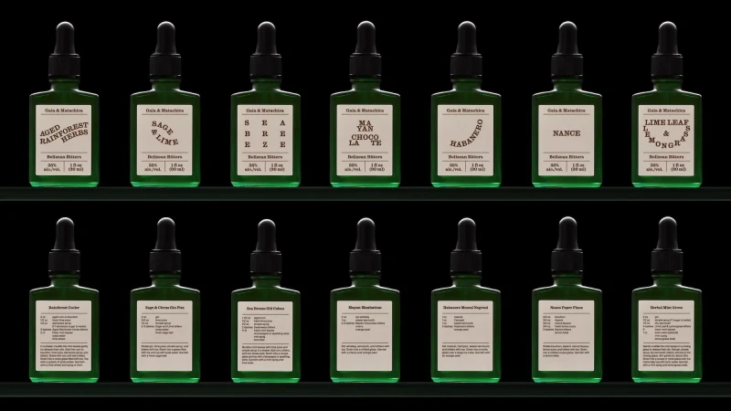 Assortment of green glass bottles with dropper caps and labels, displayed on dark green shelves, each containing artisanal bitters.