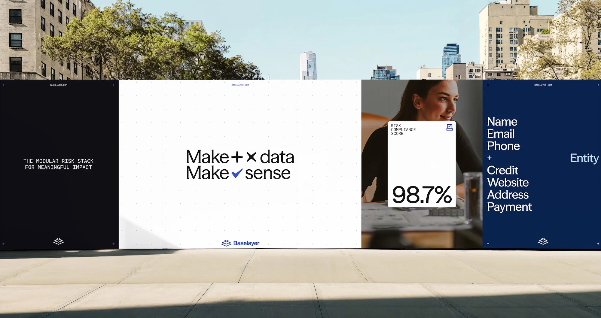 Outdoor view of Baselayer marketing posters on a sidewalk, featuring a woman, data visualization, and technology-focused messaging.