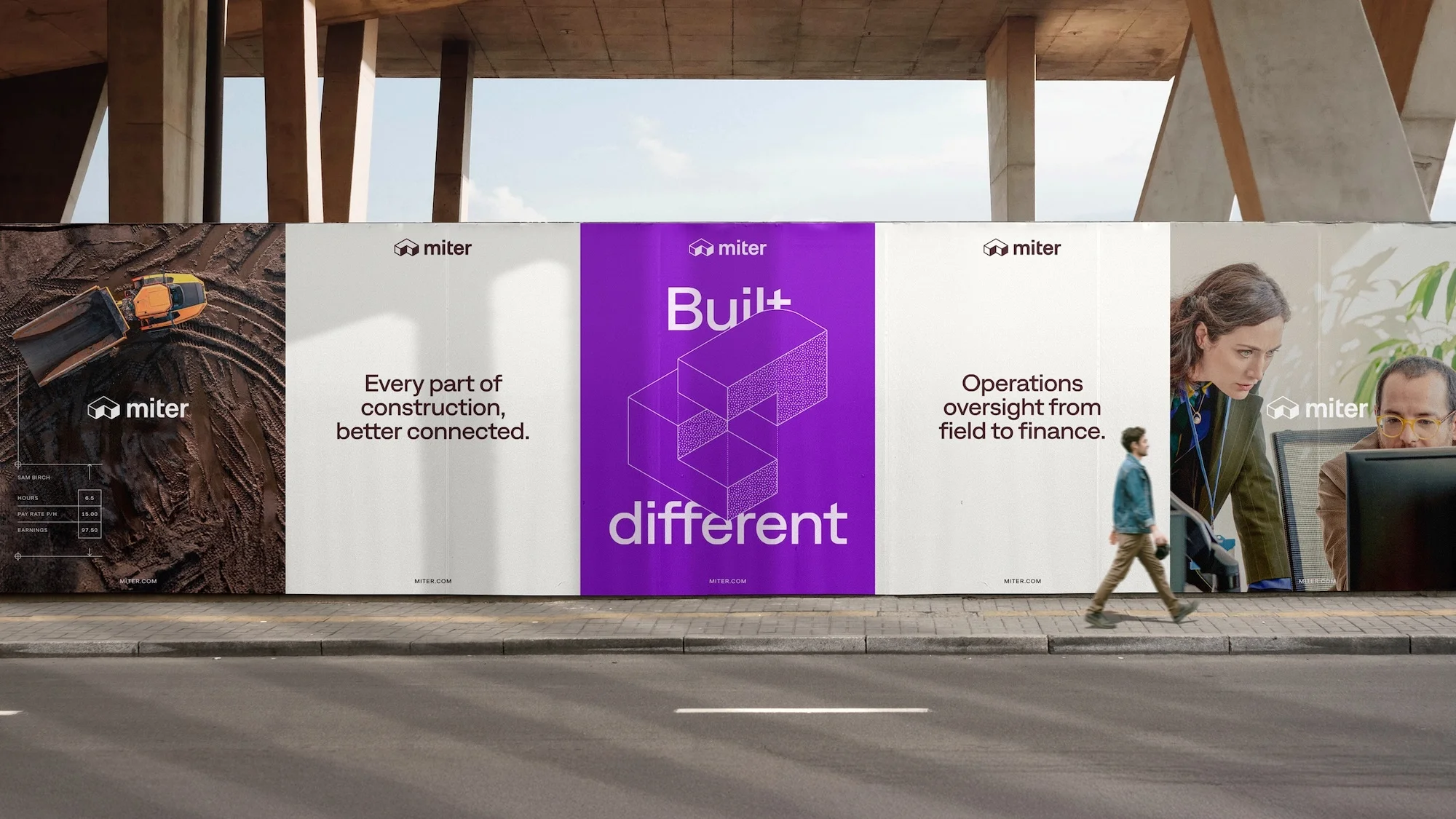 Billboard with Mitre branding displays construction images, text, and professionals with a man walking on a city sidewalk in the foreground.