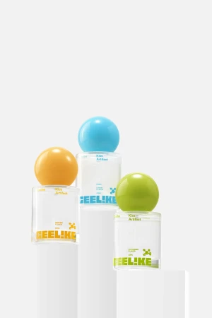 Three perfume bottles with colorful spherical caps arranged on white pedestals against a clean, white background in a studio setting.