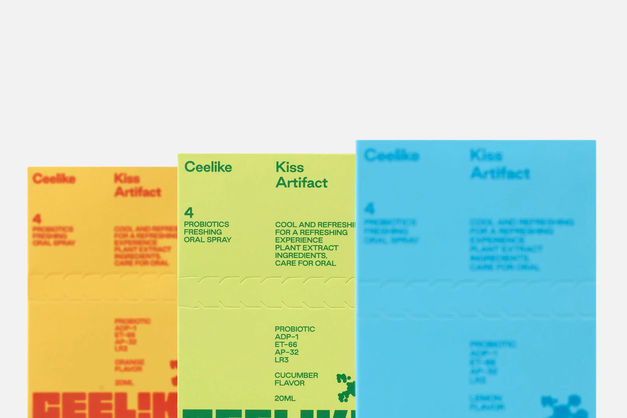 Close-up of colorful Ceelike Kiss Artifact oral spray packaging in yellow, light green, and light blue, on a white background.