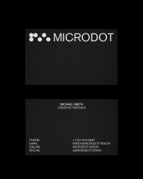 Black business cards featuring white typography and a dot logo for Microdot against a dark background