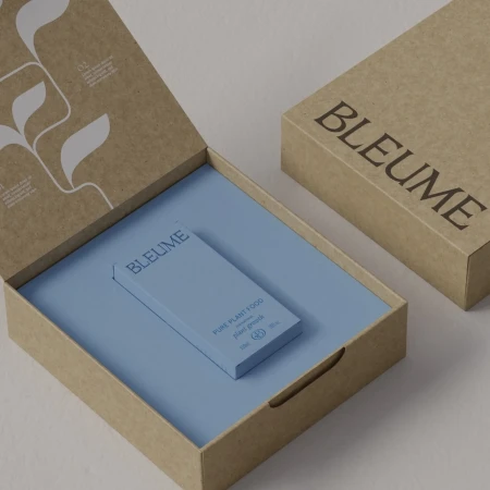 Product packaging featuring a light blue box within an open, natural cardboard box, showcasing a minimalist design for plant food products.