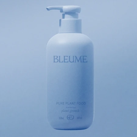 Minimalist product shot of a light blue Bleume bottle with pump dispenser on a matching background. Features simple typography.