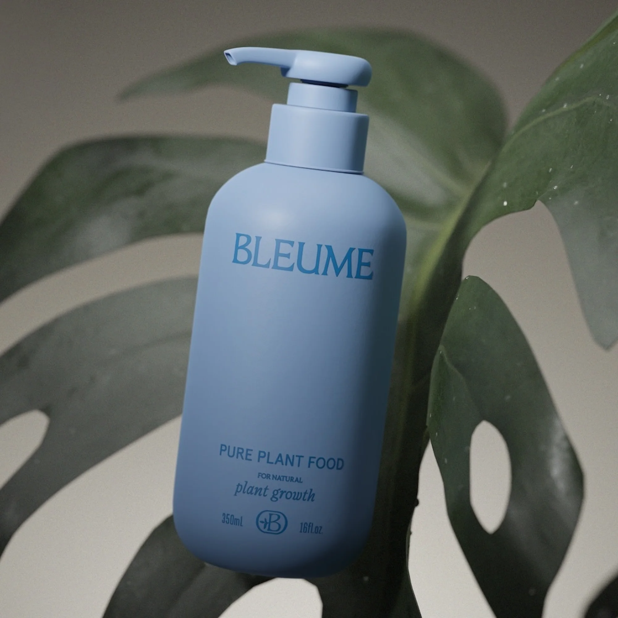 Light-blue bottle of plant food set against a large monstera leaf with a neutral background in a softly lit, close-up product shot.