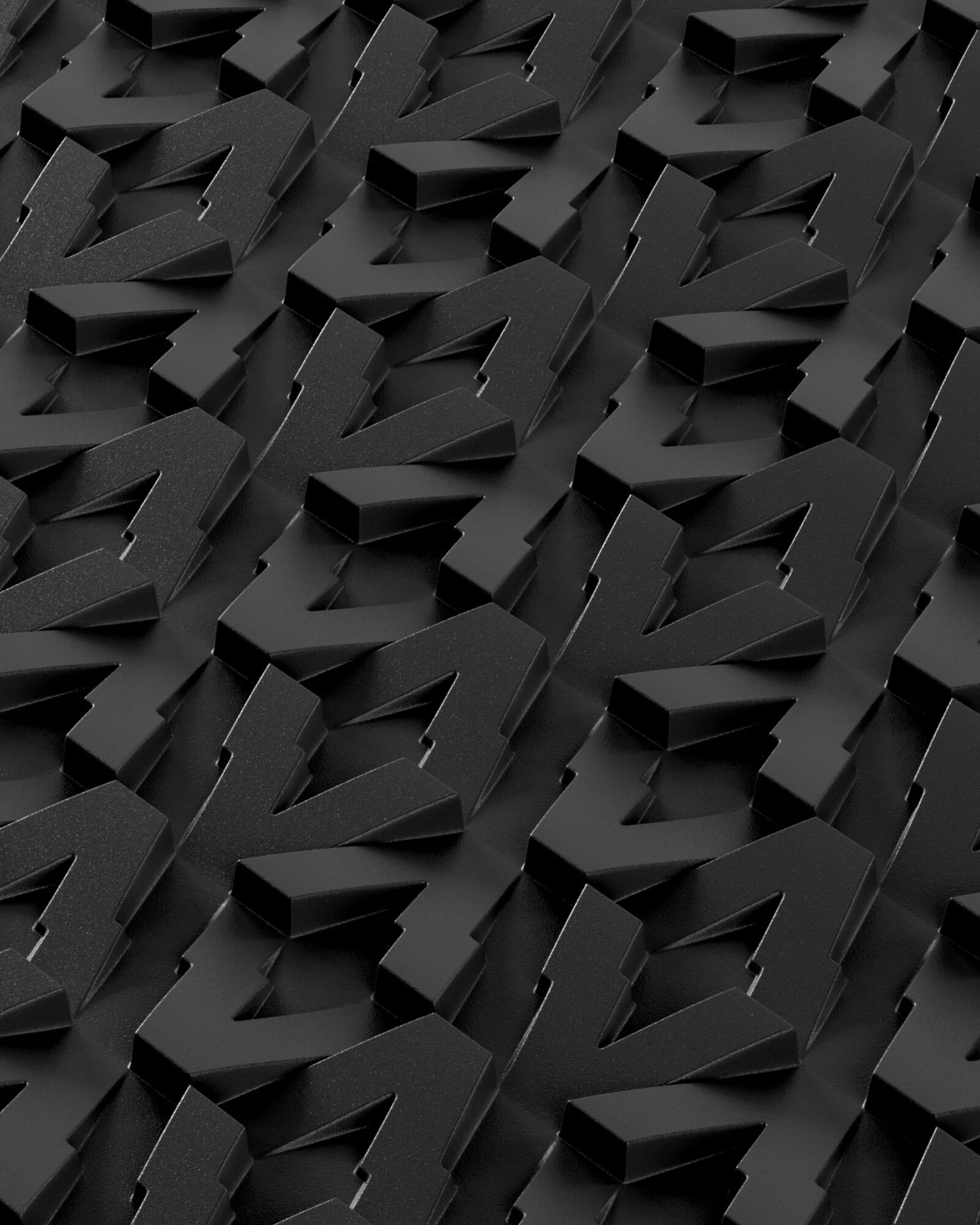 Monochromatic image showing a repeated, geometric pattern of black shapes on a flat, dark surface, creating an abstract design.