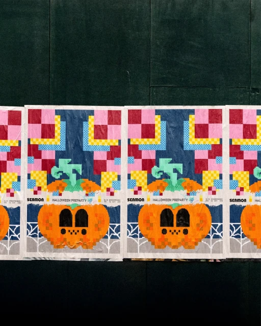 Pixelated Halloween posters featuring orange pumpkins and colorful checkerboard patterns against a dark background.