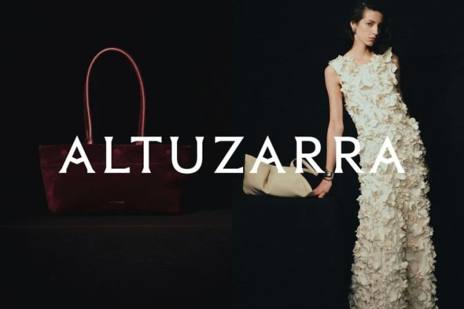 Altuzarra ad campaign image featuring a burgundy handbag and a model in a textured white dress against a dark background