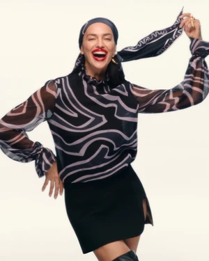 Model Irina Shayk wearing a patterned headscarf and printed blouse for Pucci Holiday 2025 ad campaign.