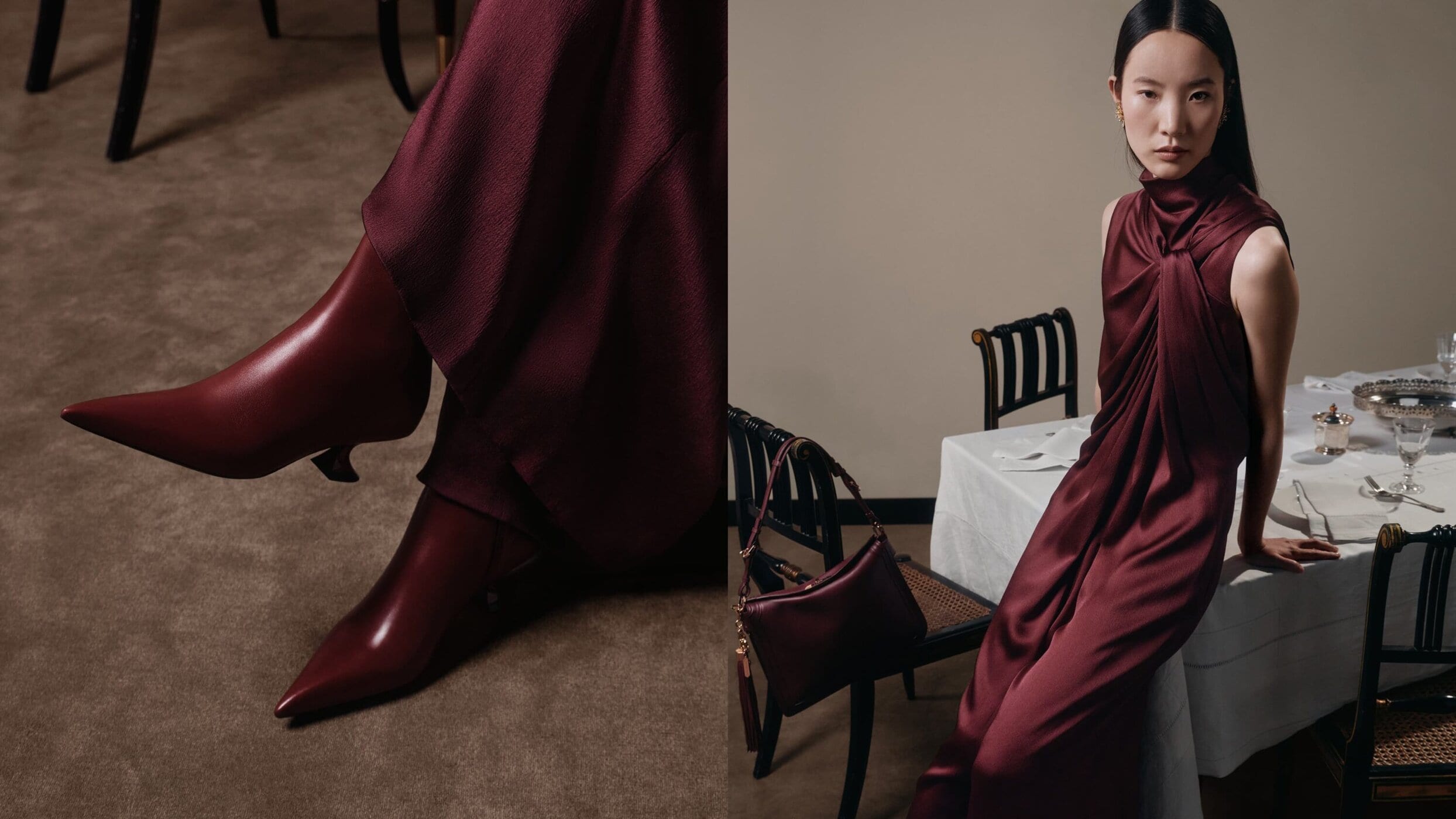 Elegant Asian woman in a draped burgundy dress and burgundy boots posing in an interior with a table and chairs.