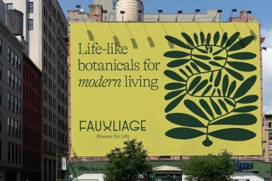 Large yellow billboard on a city building exterior featuring green botanical illustration and the brand name Fauxliage.