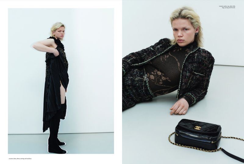 Model in a black tweed jacket and patterned top posing against a white studio background with a black quilted bag