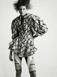 Model Rosalieke Fuchs in a textured patterned jacket and shorts against a white backdrop for Document Journal.