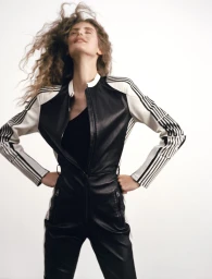 Model Rosalieke Fuchs wearing a black and white jumpsuit against a white seamless background for Document Journal.