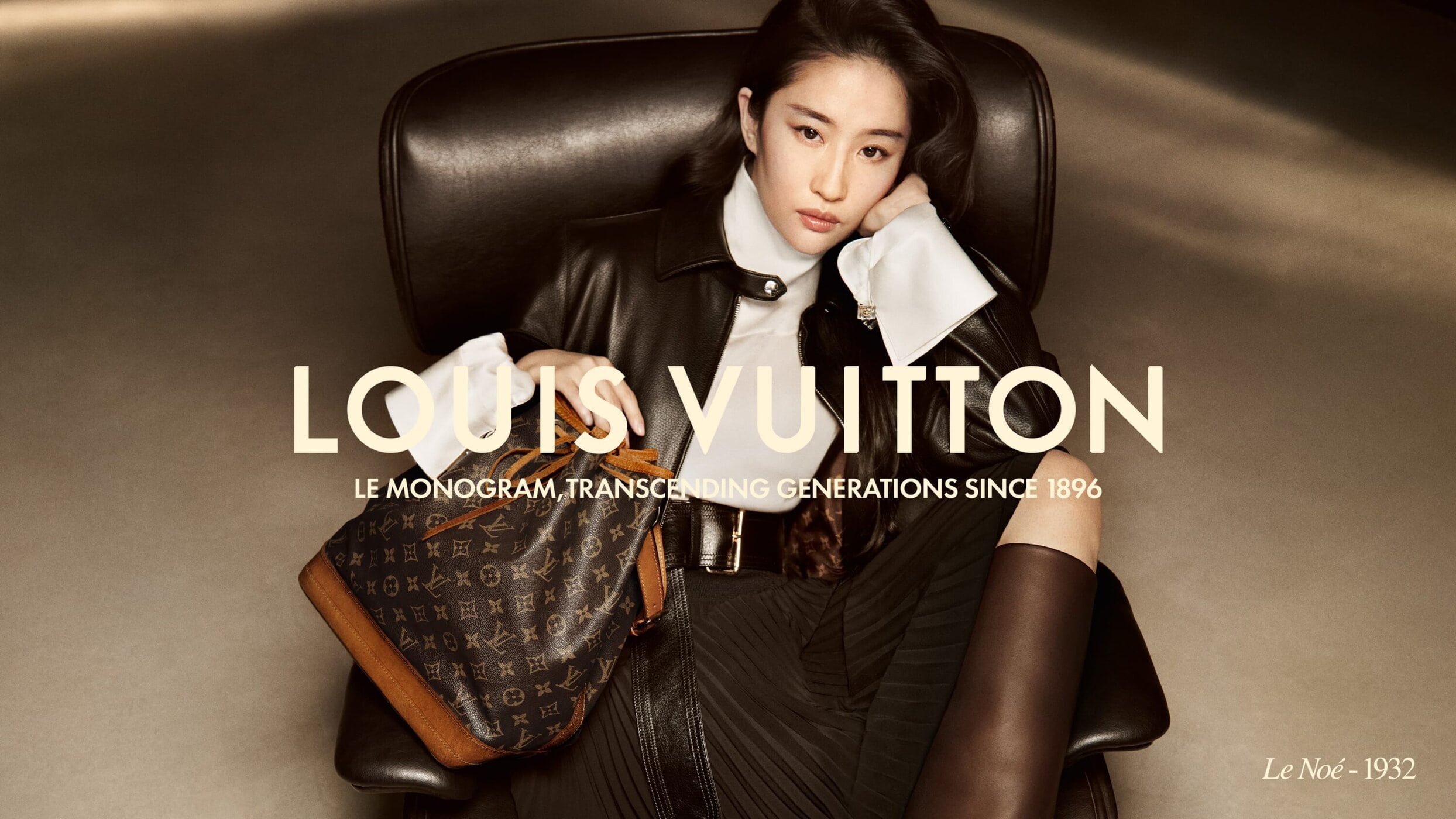 A seated woman poses with a Louis Vuitton handbag in a fashion advertisement, exuding elegance with luxury accessories and a modern style.
