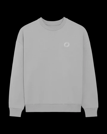 Grey long-sleeve shirt displayed on a black background, featuring a small white circular logo on the upper chest area.