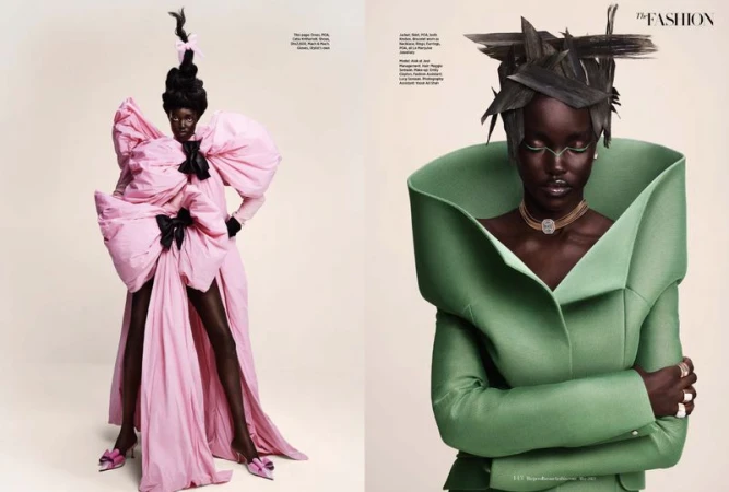 Two dark-skinned women in couture fashion, one in a pink bow gown and one in a green sculptural jacket, posing in a studio.