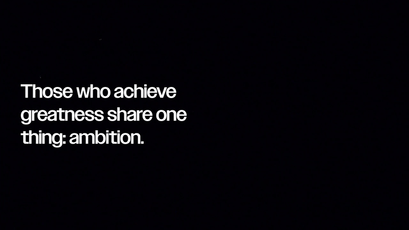 Text-based graphic on a black background featuring a motivational quote about achieving greatness and the role of ambition.