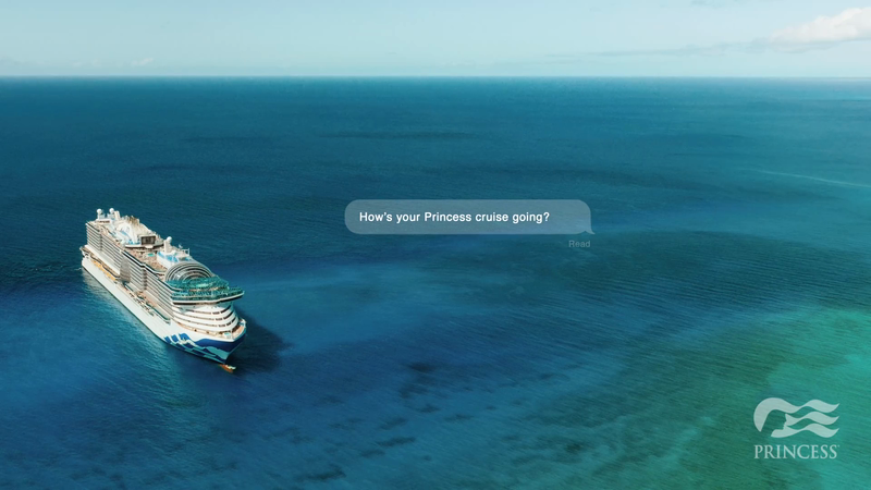 Aerial view of a white Princess cruise ship sailing through a turquoise ocean under a blue sky on a sunny day, travel advertisement.