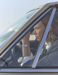 Model Annely Bouma wearing a wristwatch inside a car for Madame Figaro