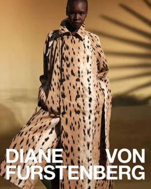 Model Alek Wek wearing a leopard print coat against a warm lit background for Diane von Furstenberg Spring 2026 campaign