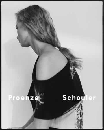 Black-and-white fashion portrait of a blonde woman in a top by Proenza Schouler, with a white backdrop and minimalist studio lighting.