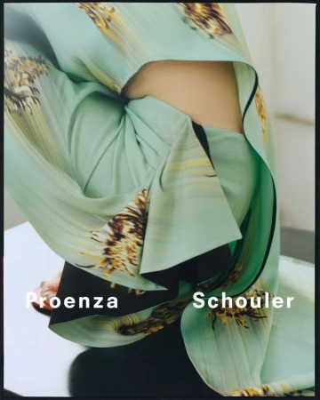 Close-up fashion shot of person wearing a light green garment with a flower pattern, showcasing Proenza Schouler brand logo.
