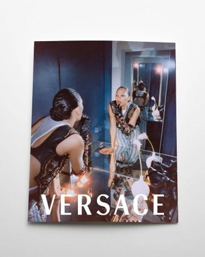 Model looking into a mirror in a campaign image for Versace S/S 2026 photographed by Frank Lebon.