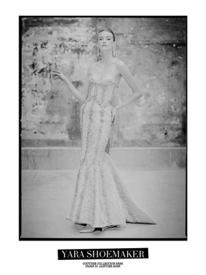 Model wearing a strapless couture gown with intricate beading against a weathered textured wall for Yara Shoemaker couture collection.