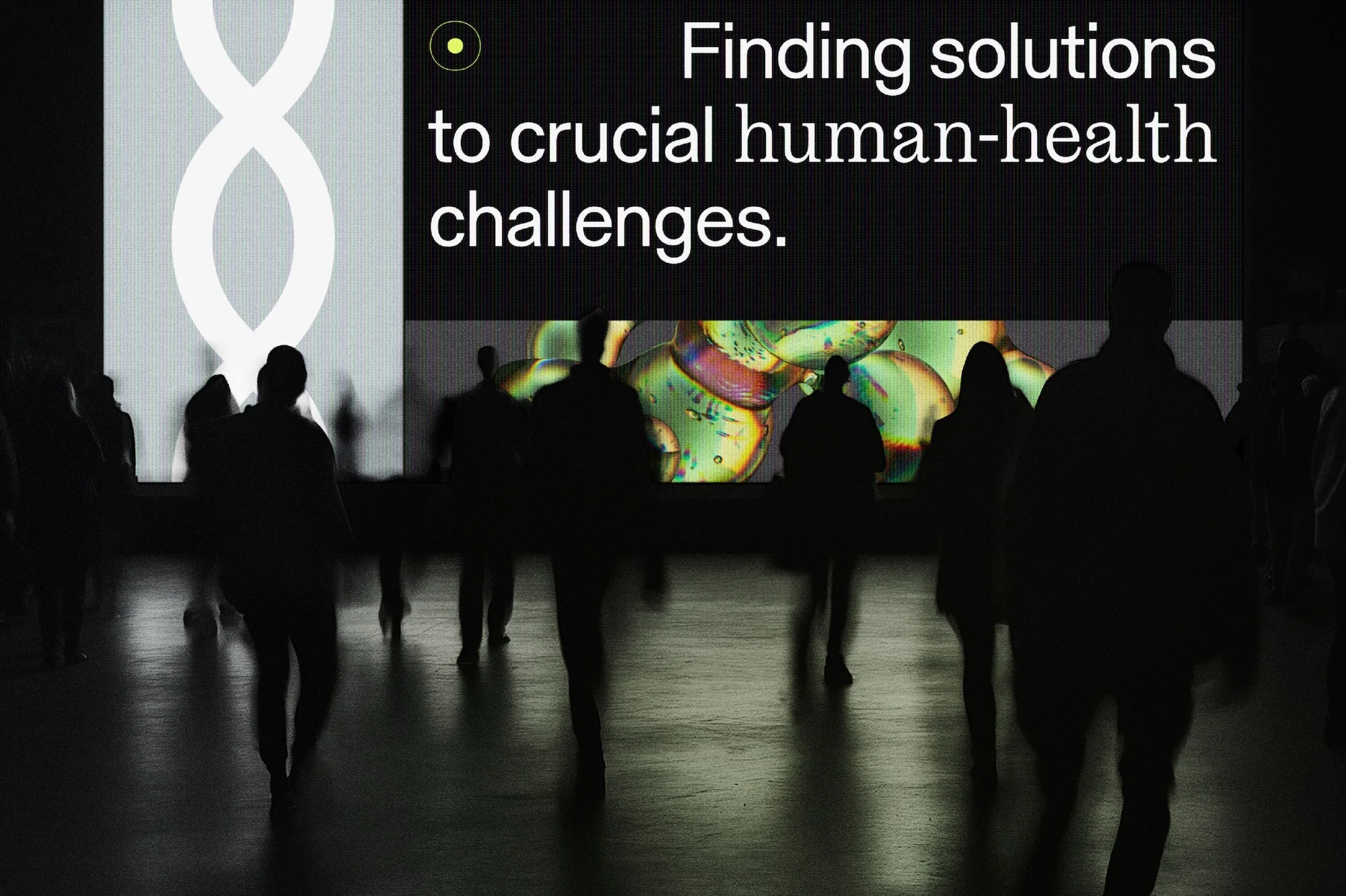 Silhouetted figures walk past digital displays of healthcare and DNA imagery in a dark, modern environment with blurred motion.