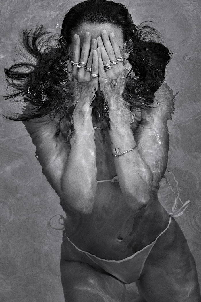 Model submerged in water with hands covering face showcasing rings and bracelets for John Hardy spring summer 2026 campaign