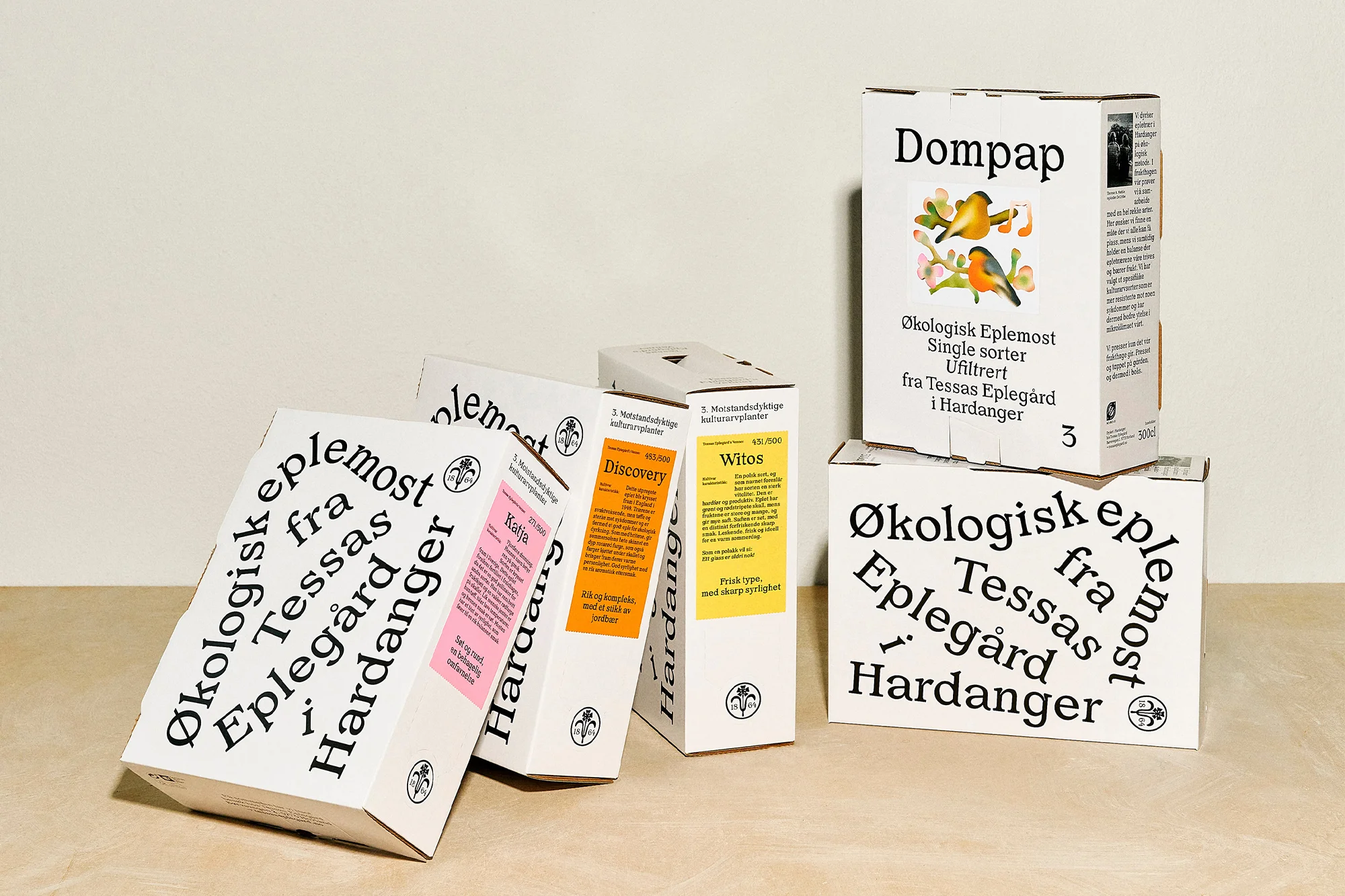 Several white cardboard boxes of juice concentrate are arranged on a light surface, with the brand name Dompap visible on one box.