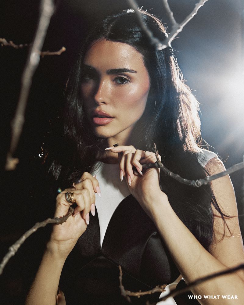 Madison Beer framed by bare tree branches in a portrait for Who What Wear, photographed by Chantal Anderson.