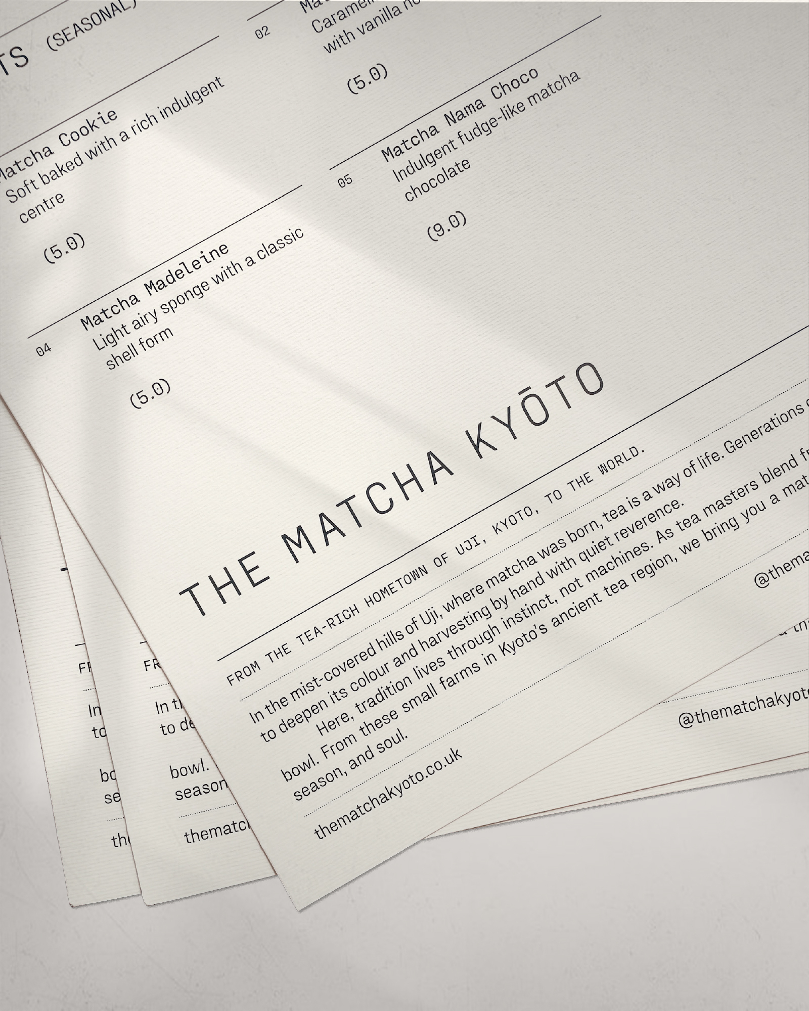Menu pages displaying Matcha Kyoto desserts and text describing the tea region, under soft light in a brightly lit indoor setting.