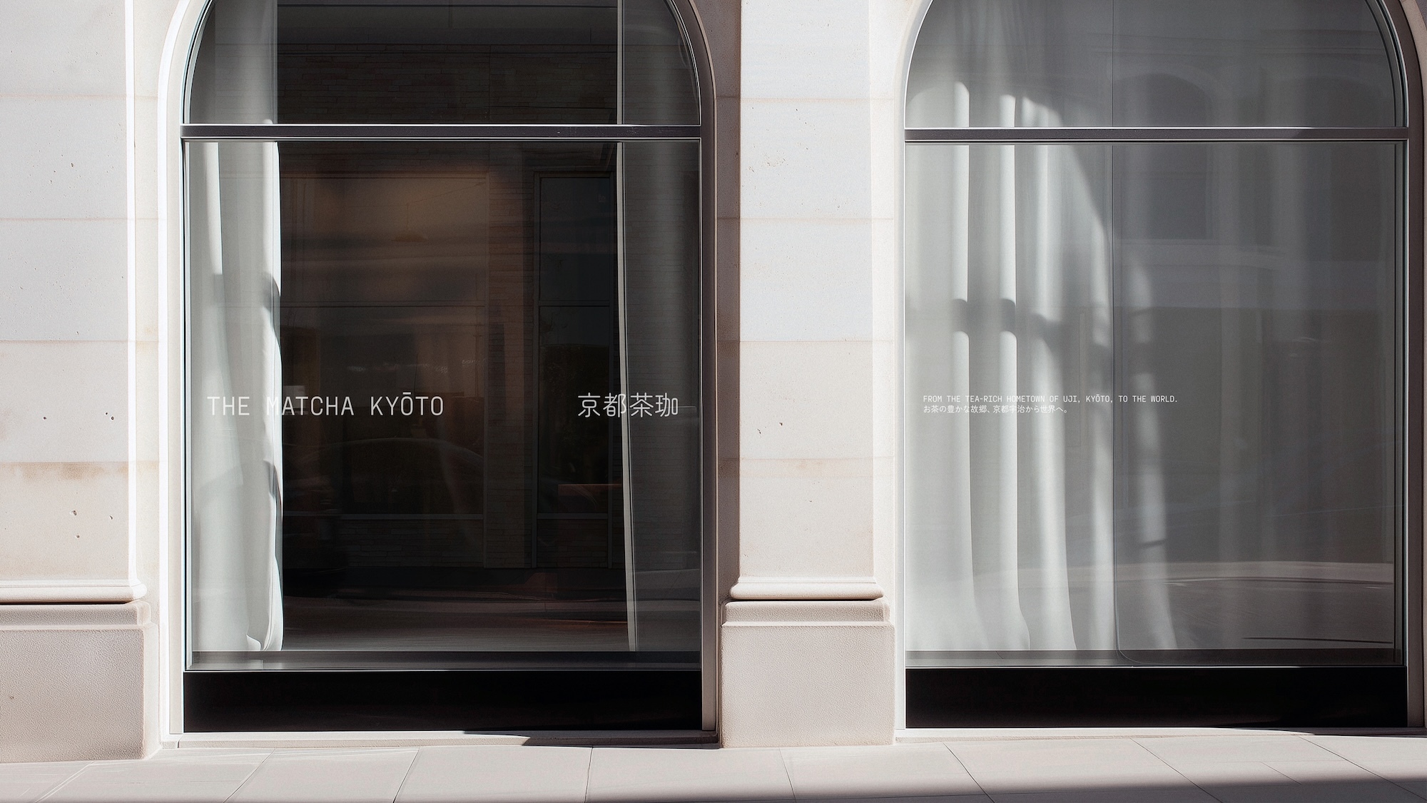 Architectural image of The Matcha Kyoto store front featuring glass windows, neutral colour palette and brand signage in English and Japanese.
