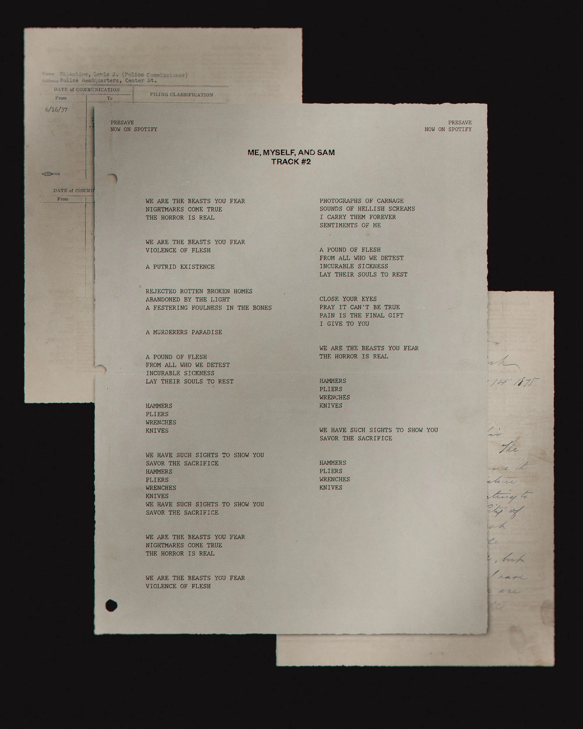 Sheets of printed lyrics for 'Me, Myself, and Sam Track #2', in a photo studio setting, featuring song lyrics and handwritten notes.