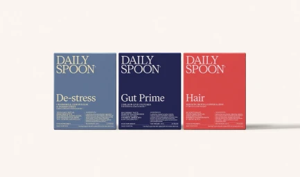 Three colorful Daily Spoon supplement product boxes aligned horizontally on a clean white surface with soft drop shadows.