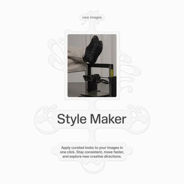 Image of a 3D printer with a shoe-like object on top of it, placed on a table against a neutral background.