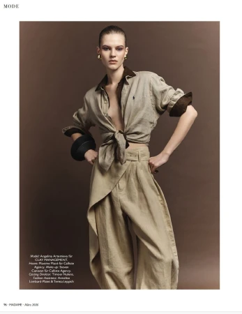 Model wearing tied safari shirt and pleated trousers standing against a brown backdrop for Madame Germany