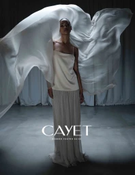 Model in flowing cream dress framed by billowing white fabric in the Cayet FW24 campaign shot by Frederico Martins.