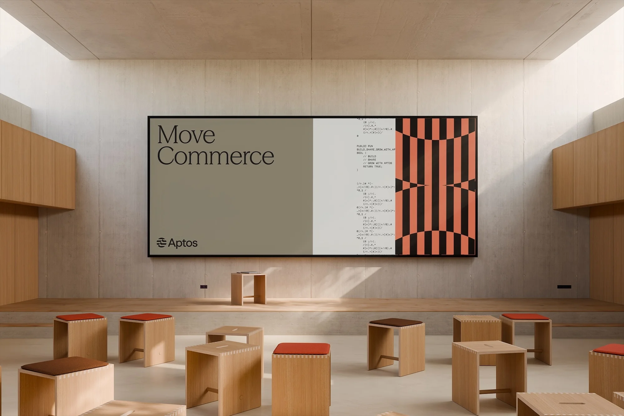 Interior space with a large display showing 'Move Commerce' and code, surrounded by small wooden stools and light walls.